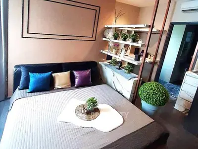 Modern bedroom with stylish decor and cozy ambiance, featuring a comfortable bed and elegant shelving.