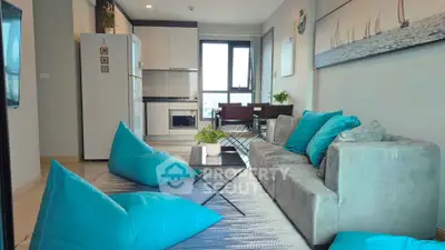 Modern living room with stylish decor and vibrant blue accents in a cozy apartment setting.