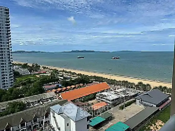 Stunning beachfront view from high-rise apartment overlooking ocean and coastline.