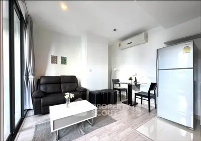 Modern living room with sleek furniture and large windows in a stylish apartment.