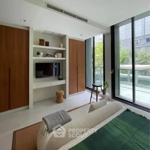 Modern living room with large windows and stylish decor in urban apartment
