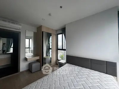 Modern bedroom with large windows and city view, featuring a minimalist design and ample natural light.