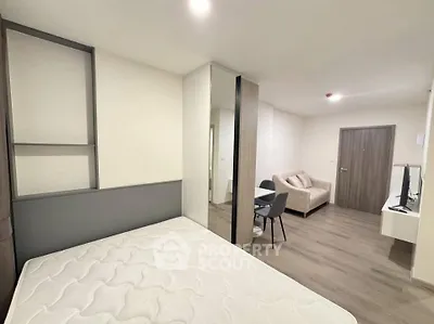 Modern studio apartment with open layout, featuring a cozy living area and stylish furnishings.