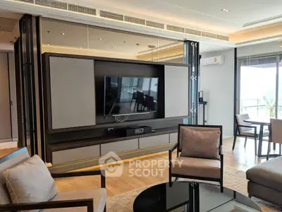 Modern living room with sleek TV setup and stylish furniture in a contemporary apartment.