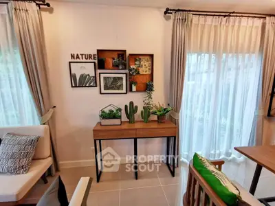 Stylish living room with modern decor and natural light, featuring elegant furniture and lush greenery.