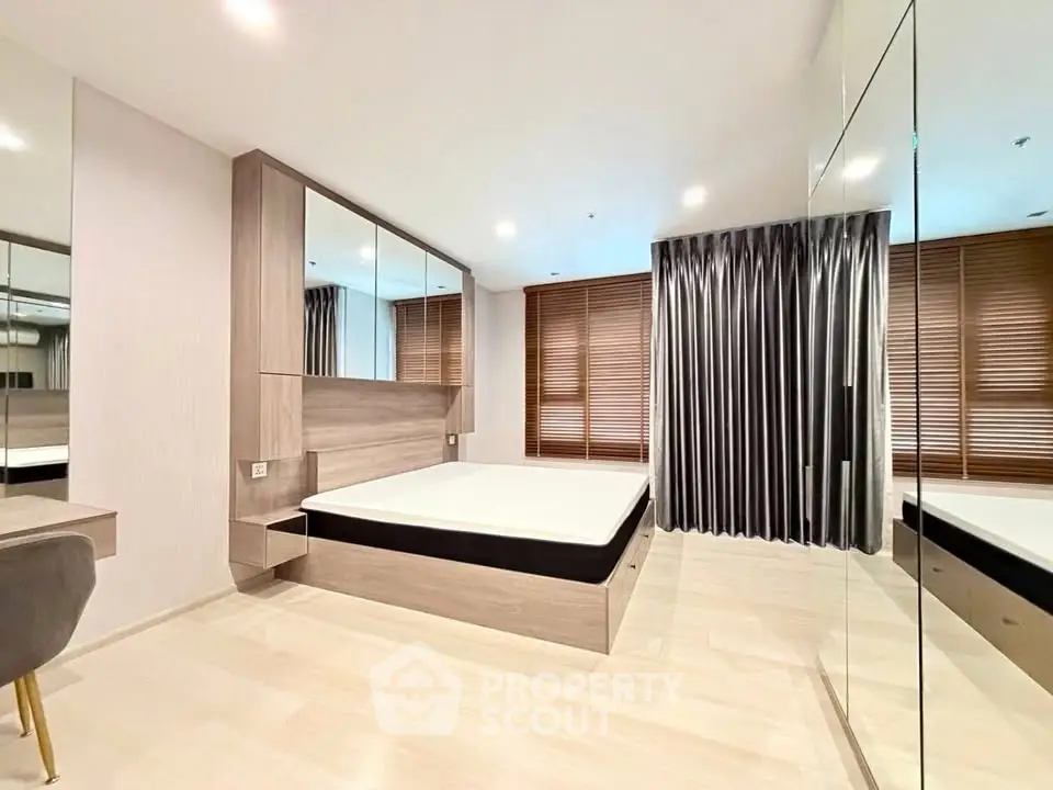 Modern bedroom with mirrored wardrobe and stylish decor