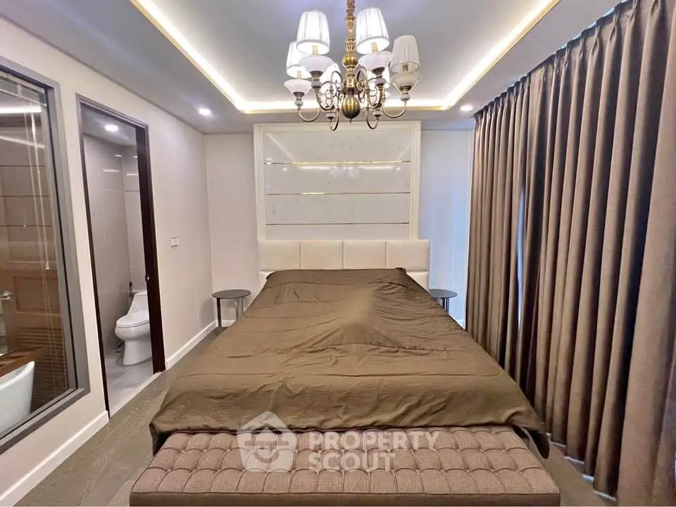 Luxurious bedroom with elegant chandelier and modern decor