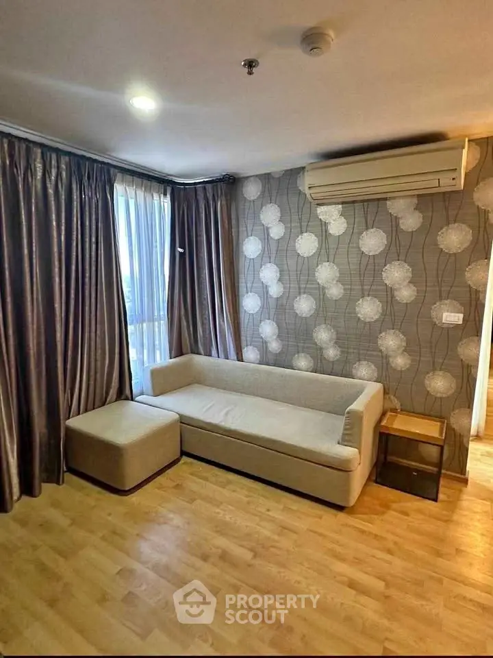 Stylish living room with modern sofa, elegant curtains, and chic wallpaper design.