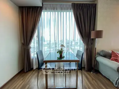 Stylish living room with floor-to-ceiling window and elegant decor in modern apartment.