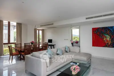 Spacious living room with modern decor and large windows offering natural light.