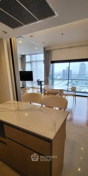 Modern open-layout living room with city view and stylish furniture