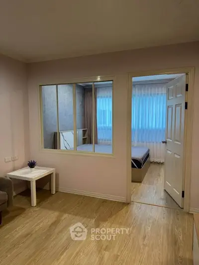Cozy apartment interior with wooden flooring and bedroom view, perfect for modern living.