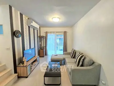 Modern living room with stylish decor and comfortable seating in a cozy apartment.