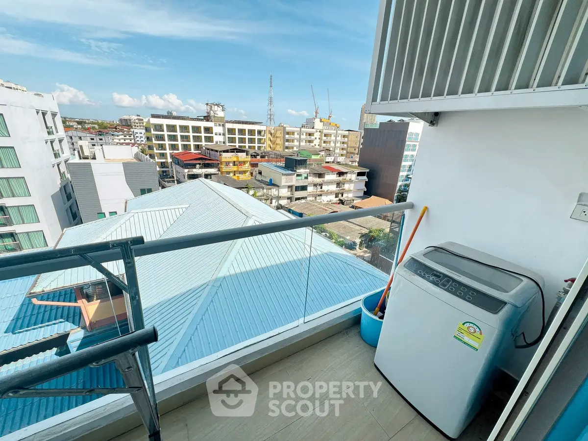 Modern balcony with city view and washing machine, ideal for urban living.