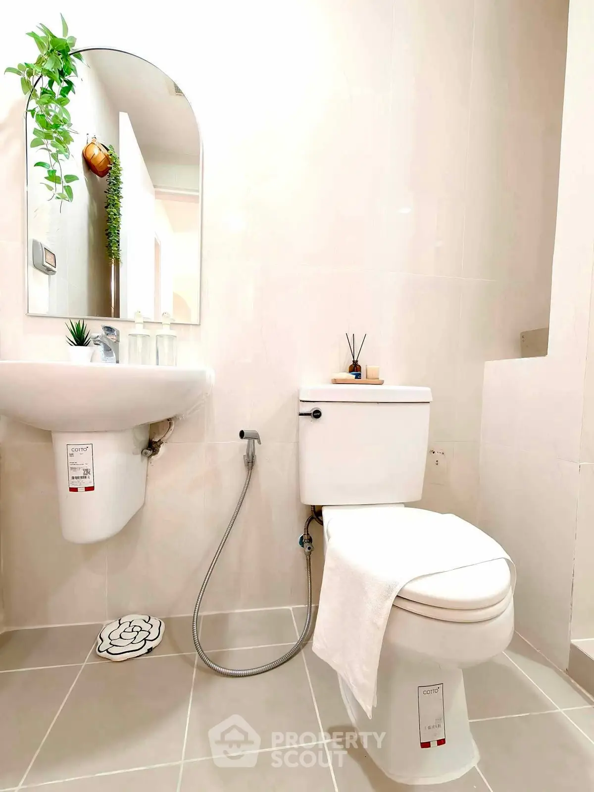 Modern bathroom with sleek fixtures and elegant decor, featuring a stylish mirror and contemporary toilet.