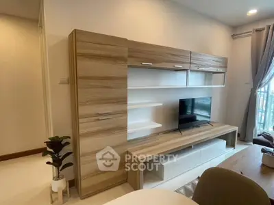 Modern living room with stylish wooden entertainment unit and flat-screen TV, perfect for cozy relaxation.