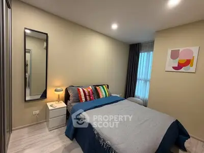 Cozy modern bedroom with stylish decor and ample natural light