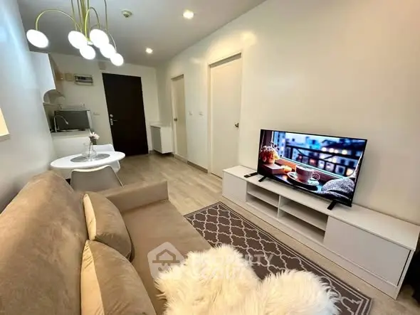 Modern living room with cozy sofa, stylish lighting, and flat-screen TV