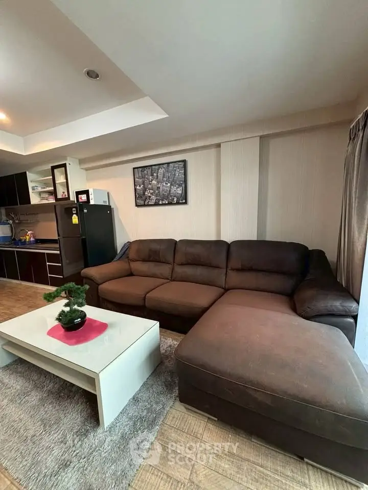 Spacious living room with cozy brown sectional sofa and modern decor