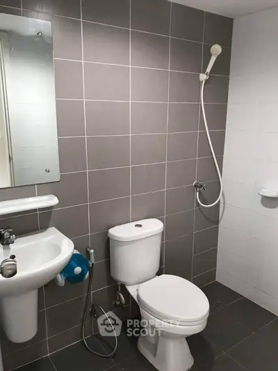 Modern bathroom with sleek fixtures and neutral tile design.