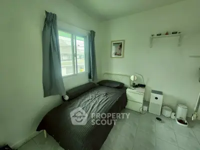 Cozy bedroom with natural light and modern decor, perfect for relaxation and comfort.