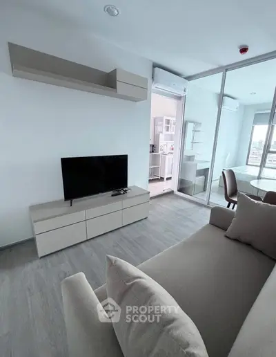 Modern living room with sleek furniture and open layout in a stylish apartment.
