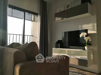 Modern living room with sleek furniture and balcony view, perfect for urban living.