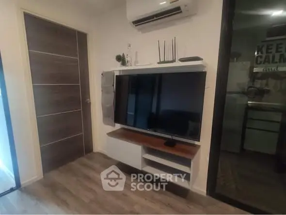 Modern living room with wall-mounted TV and air conditioning unit