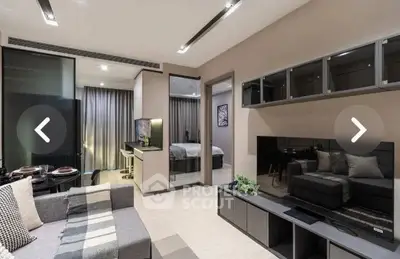 Modern open-plan living room with stylish decor and view into bedroom