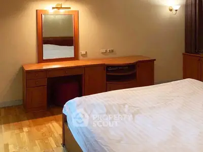 Spacious bedroom with wooden furniture and cozy lighting