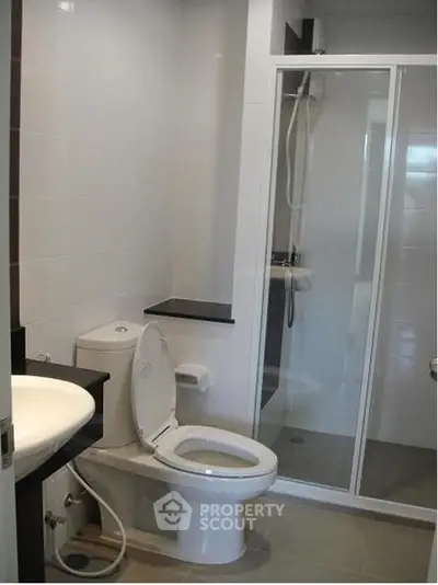 Modern bathroom with glass shower and sleek fixtures in a contemporary home.
