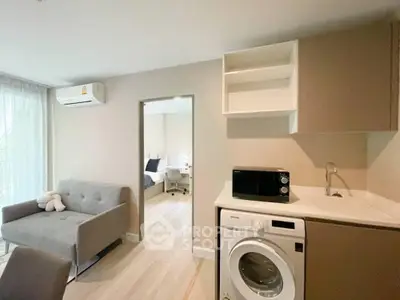 Modern apartment interior with washing machine and cozy living area