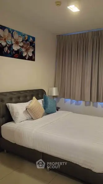 Cozy bedroom with elegant decor and plush bedding in a modern apartment.