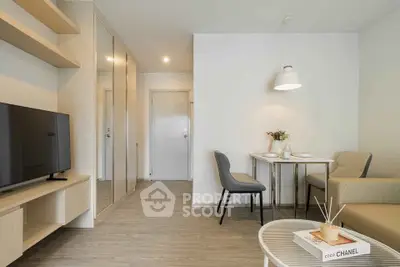 Modern living room with stylish furniture and dining area in a cozy apartment.