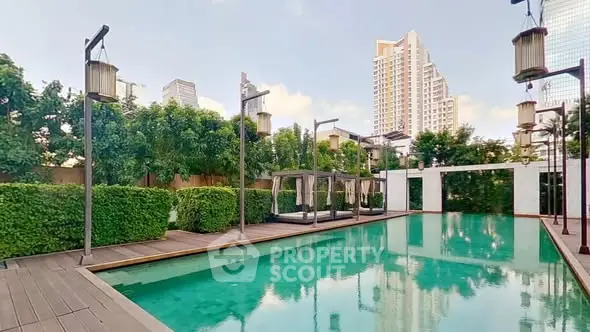 Luxurious outdoor pool area with modern design and lush greenery in a high-rise residential complex.