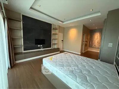 Spacious modern bedroom with sleek design and built-in storage