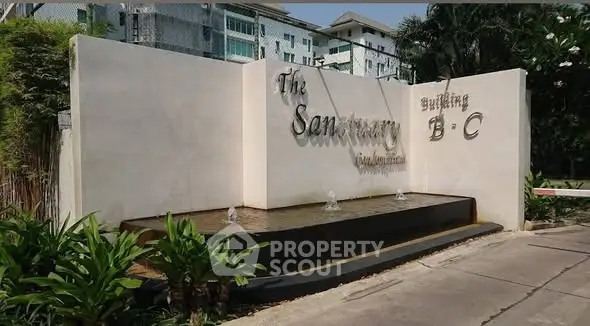 Elegant entrance of The Sanctuary Building B-C with water feature and lush greenery.