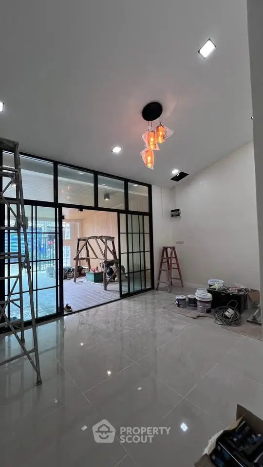 Spacious modern living room with glass partition and elegant lighting