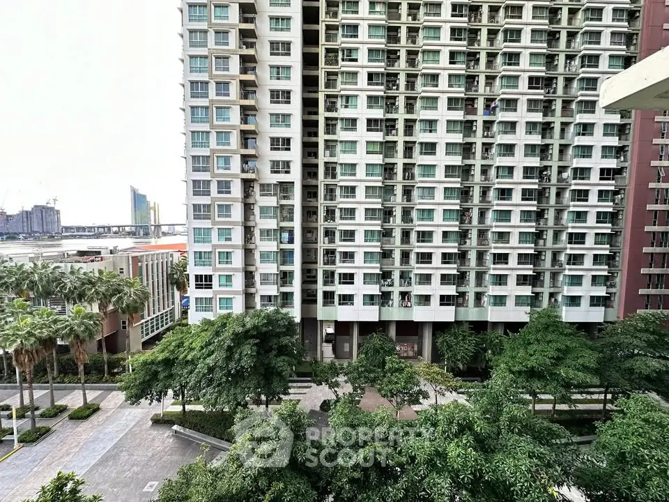 High-rise residential building with lush greenery and city view
