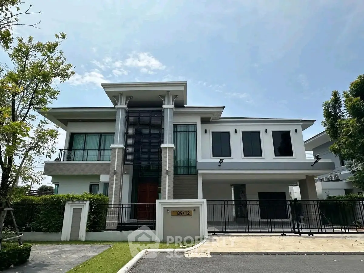 Stunning modern two-story house with sleek design and lush greenery, perfect for luxurious living.