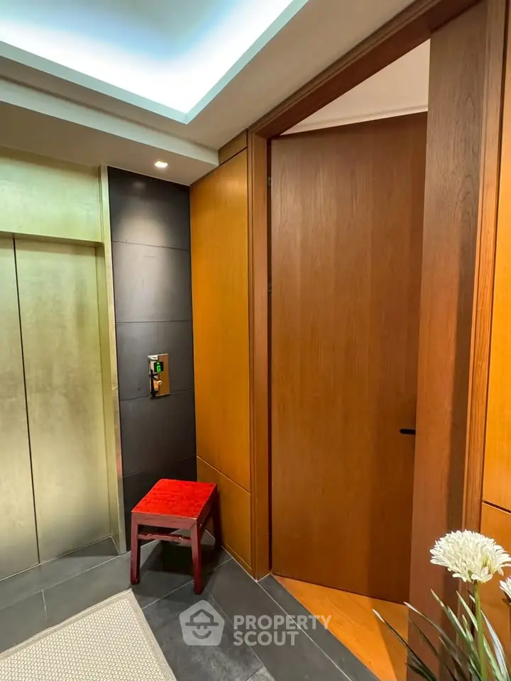 Luxurious elevator lobby with elegant wood paneling and modern lighting