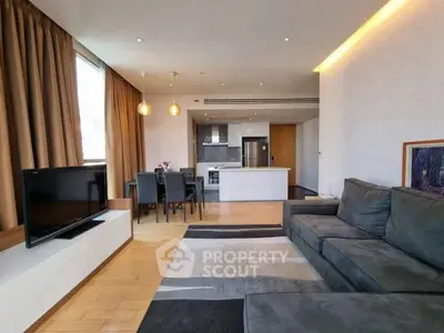 Modern open-plan living room with sleek kitchen and cozy seating area