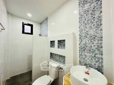 Modern bathroom with stylish mosaic tiles and sleek fixtures