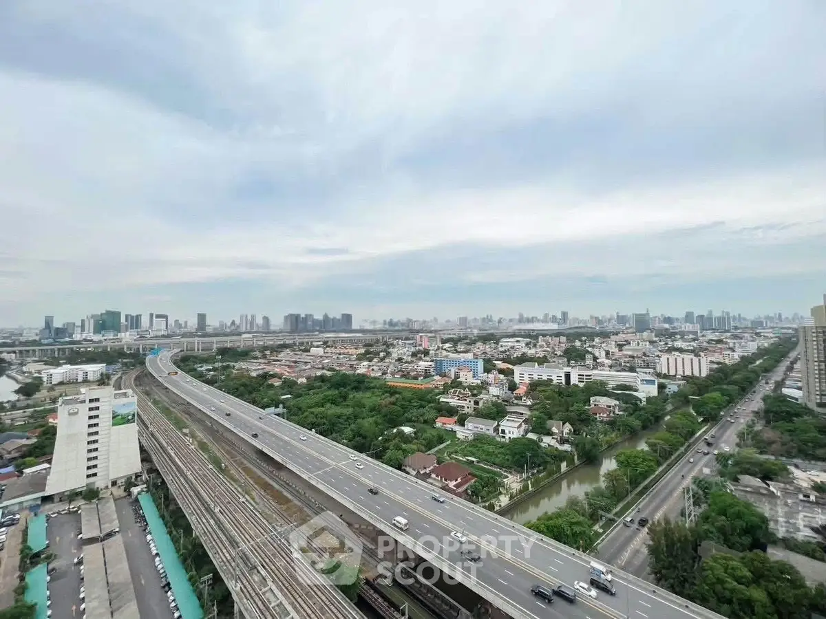 Stunning cityscape view from high-rise building showcasing urban skyline and major highway.