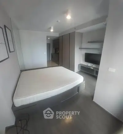 Modern bedroom with sleek design and built-in storage solutions.