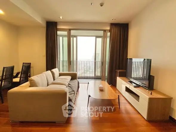 Spacious living room with modern furniture and large windows offering a stunning view.