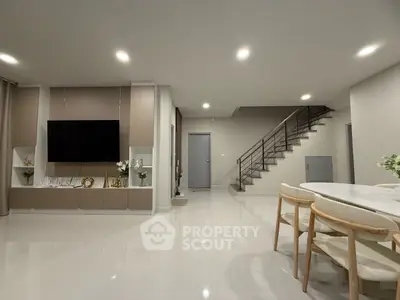 Modern living room with sleek design, open space, and elegant staircase, perfect for contemporary living.