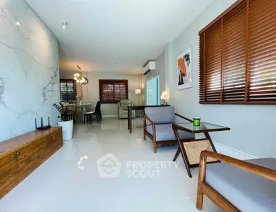 Modern living room with stylish furniture and large windows, perfect for relaxation.