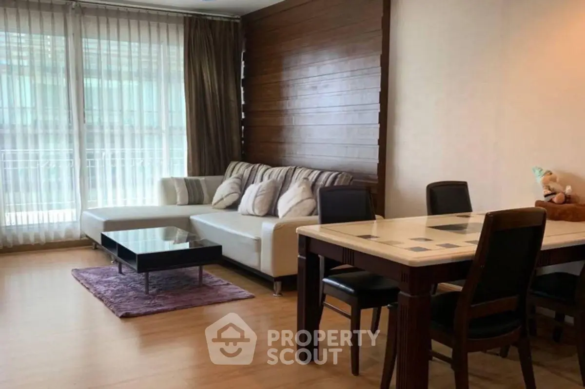 Spacious living room with modern decor and large windows for natural light.