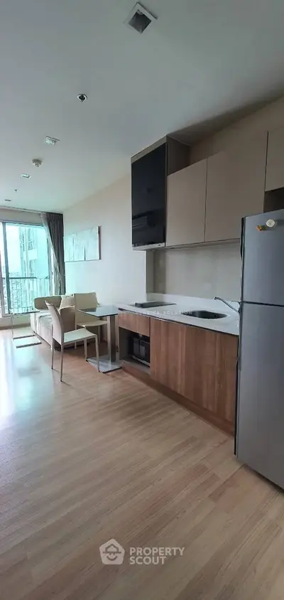 Modern kitchen with open layout and dining area in a stylish apartment